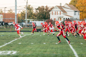 NH highscool youth football photography by Leatherhead Sports Media. Spaulding Red Raiders. Friday night lights.