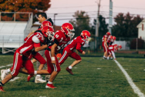 NH highscool youth football photography by Leatherhead Sports Media. Spaulding Red Raiders. Friday night lights.