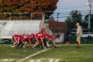 NH highscool youth football photography by Leatherhead Sports Media. Spaulding Red Raiders. Friday night lights.