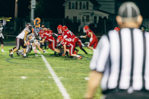 NH highscool youth football photography by Leatherhead Sports Media. Spaulding Red Raiders. Friday night lights.