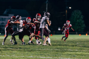 NH highscool youth football photography by Leatherhead Sports Media. Spaulding Red Raiders. Friday night lights.